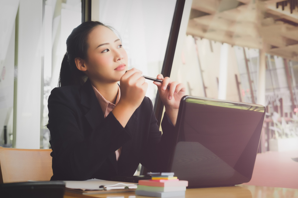 Woman in the Office Thinking of Ideas for Work